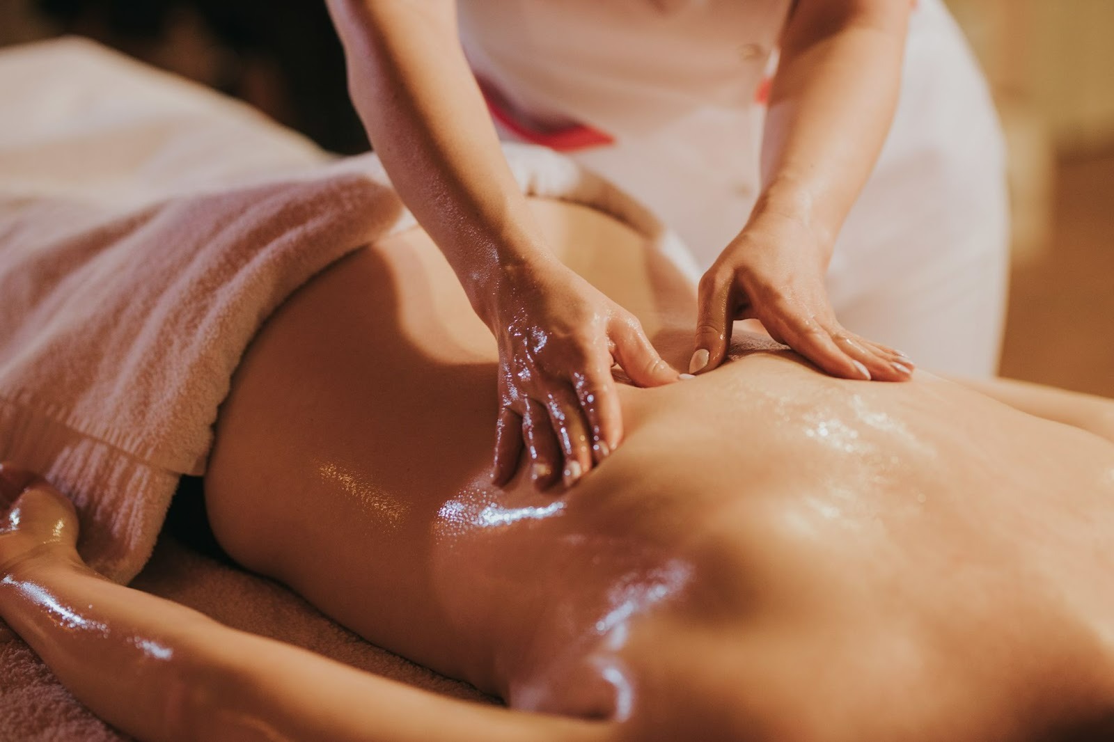 Masseuse giving a back massage to a guest