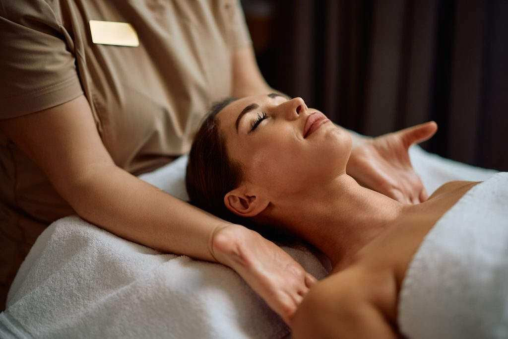 Woman relaxing with eyes closed during massage.